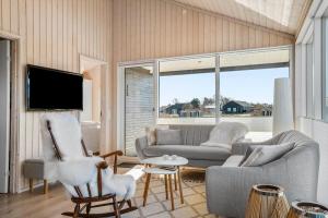 un soggiorno con divano, sedie e TV di 8218-Lundby-Soloje-Strandvej-20 a Lundby