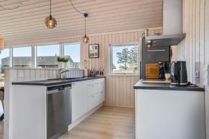 una cucina con mobili bianchi e un piano di lavoro di 8218-Lundby-Soloje-Strandvej-20 a Lundby Altre 16 foto