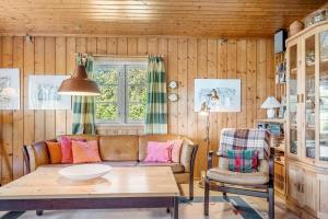 a living room with a couch and a table at 7057-Bogo-By-Mollebakken-67 in Bogø By