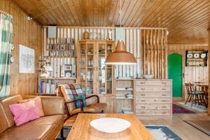 a living room with a couch and a table at 7057-Bogo-By-Mollebakken-67 in Bogø By +13 photos