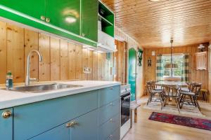 a kitchen with a sink and a table with chairs at 7057-Bogo-By-Mollebakken-67 in Bogø By