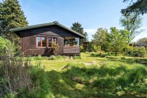 a small cabin in the middle of a field at 7057-Bogo-By-Mollebakken-67 in Bogø By