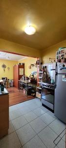 a kitchen with a refrigerator and a stove at Viña acogedor lugar a pasos del reloj de flores in Viña del Mar