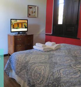 En eller flere senge i et værelse på La Nueva Casona Italiana