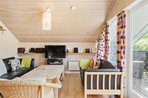a living room with a couch and a table at OH123-Storvorde-Kongeornen-3 in Storvorde