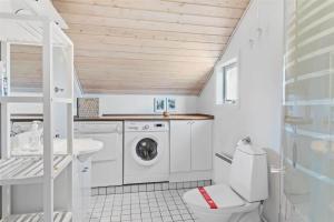 a white bathroom with a washer and dryer in it at OH123-Storvorde-Kongeornen-3 in Storvorde