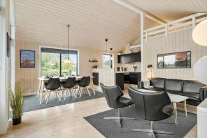 a living room and kitchen with a table and chairs at OH419-Hadsund-Halvrebene-60 in Hadsund