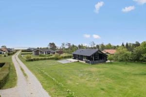 a house in a field next to a dirt road at OH419-Hadsund-Halvrebene-60 in Hadsund