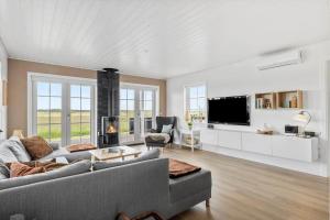 a living room with a couch and a tv at OH362-Storvorde-Kongeornen-74 in Storvorde