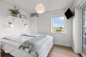 a white bedroom with a bed and a window at OH362-Storvorde-Kongeornen-74 in Storvorde