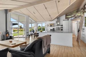 a kitchen and living room with a couch and a table at OH449-Hadsund-Haslevgarde-Eng-49 in Hadsund
