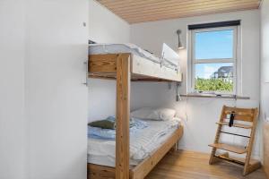 a bedroom with a bunk bed and a window at OH449-Hadsund-Haslevgarde-Eng-49 in Hadsund