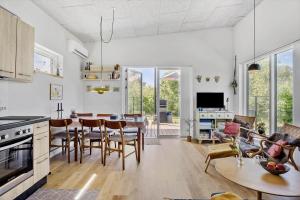 a kitchen and living room with a table and chairs at OH520-Hadsund-Sletten-132 in Hadsund +13 photos