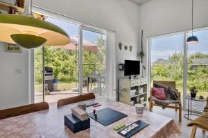 a living room with a table and a large window at OH520-Hadsund-Sletten-132 in Hadsund
