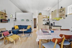a living room with a blue couch and a table at OH520-Hadsund-Sletten-132 in Hadsund