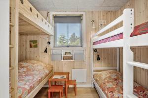 a bedroom with two bunk beds and a desk at OH520-Hadsund-Sletten-132 in Hadsund