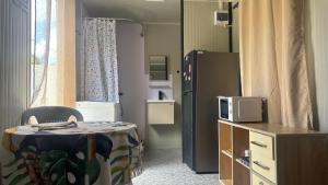 a hospital room with a refrigerator and a table at Cosy studio in Port Louis