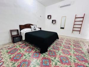 a bedroom with a bed and a rug at Casa Playa Blanca in Progreso +33 photos