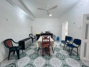a room with a table and chairs and a piano at Casa Playa Blanca in Progreso