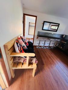 a room with a bunk bed with chairs in it at Oro y Miel in Callaqui +4 photos