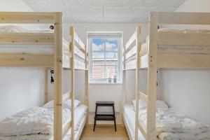 two bunk beds in a room with a window at OH292-Hadsund-Stenkisten-108 in Hadsund +16 photos