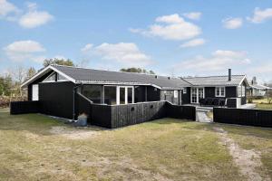 a black house with a fence in front of it at OH292-Hadsund-Stenkisten-108 in Hadsund