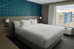 a bedroom with a large white bed and a window at Comfort Inn & Suites Colby in Colby