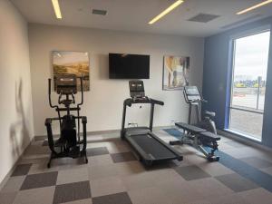 a gym with two tread machines and a flat screen tv at Comfort Inn & Suites Colby in Colby