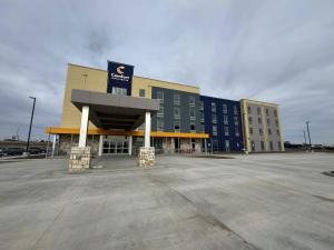 an empty parking lot in front of a building at Comfort Inn & Suites Colby in Colby