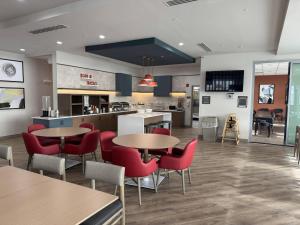 a restaurant with tables and chairs and a kitchen at Comfort Inn & Suites Colby in Colby
