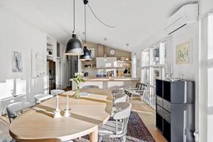una cucina e una sala da pranzo con tavolo e sedie in legno di HA318-Hals-Merkurvej-73 a Hals