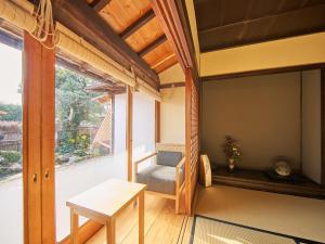 ein Zimmer mit einem Bett und einem Tisch und einem Fenster in der Unterkunft Himeji Castle's inner sanctum 400-year-old - Vacation STAY 16474 in Fukusaki