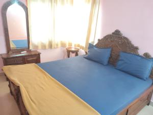 En eller flere senge i et værelse på Richnest Apartment and villas Colva