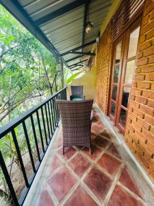 a balcony with a table and chairs on it at NILGIRA VILLA By LILYS in Badulla