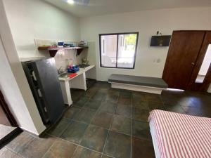 eine Küche mit einem großen Fliesenboden und einem Fenster in der Unterkunft Costa Ayala - Bungalow 5 with 2dbl beds and 1 sofa in Los Ayala