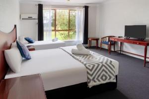 En eller flere senge i et værelse på Golf Place Inn Wollongong + 55 billeder