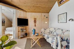 a living room with a couch and a tv at OH525-Hadsund-Halvrebene-70 in Hadsund
