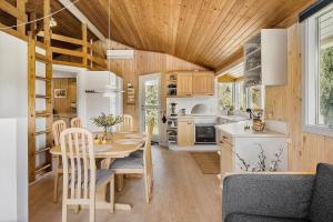 a kitchen and dining room with a table and chairs at OH525-Hadsund-Halvrebene-70 in Hadsund