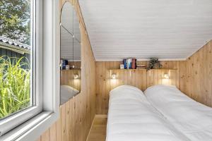 a bed in a room with a window at OH525-Hadsund-Halvrebene-70 in Hadsund