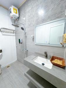 a bathroom with a sink and a shower at Mộc Châu House in Mộc Châu +54 photos