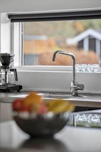 a bowl of fruit sitting next to a sink at OH534-Hadsund-Haslevgarde-Eng-2 in Hadsund +21 photos