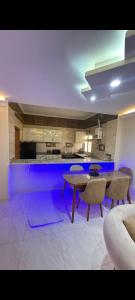 a kitchen with a table and chairs in a room at عماره 11 in 6th Of October