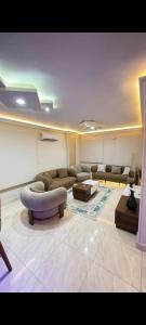 a living room with a couch and a table at عماره 11 in 6th Of October