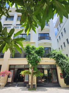 ein Gebäude mit einem Baum davor in der Unterkunft Timi Homestay Near the Wave Park Ocean Park 2 in Hòa Bình