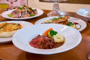 a table full of plates of food on a table at Casa Allegra in Yamanakako +51 photos