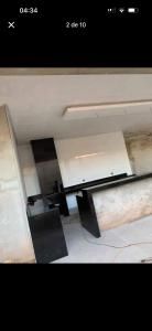 a picture of a ceiling with a table and a chair at Casa bosque in São Paulo