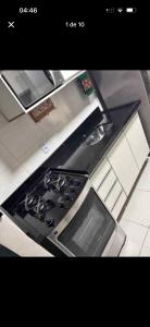 a kitchen with a stove top oven in a kitchen at Casa bosque in São Paulo