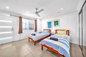 una camera da letto con due letti e una finestra di Panoramic Oceanview Villa a Bowen