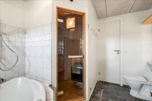 een badkamer met een bad, een toilet en een wastafel bij 715-Thyboron-Limfjordsvej-17-a in Thyborøn