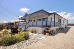 een huis met planten ervoor bij Oceanfront Escape Kilcunda in Kilcunda
